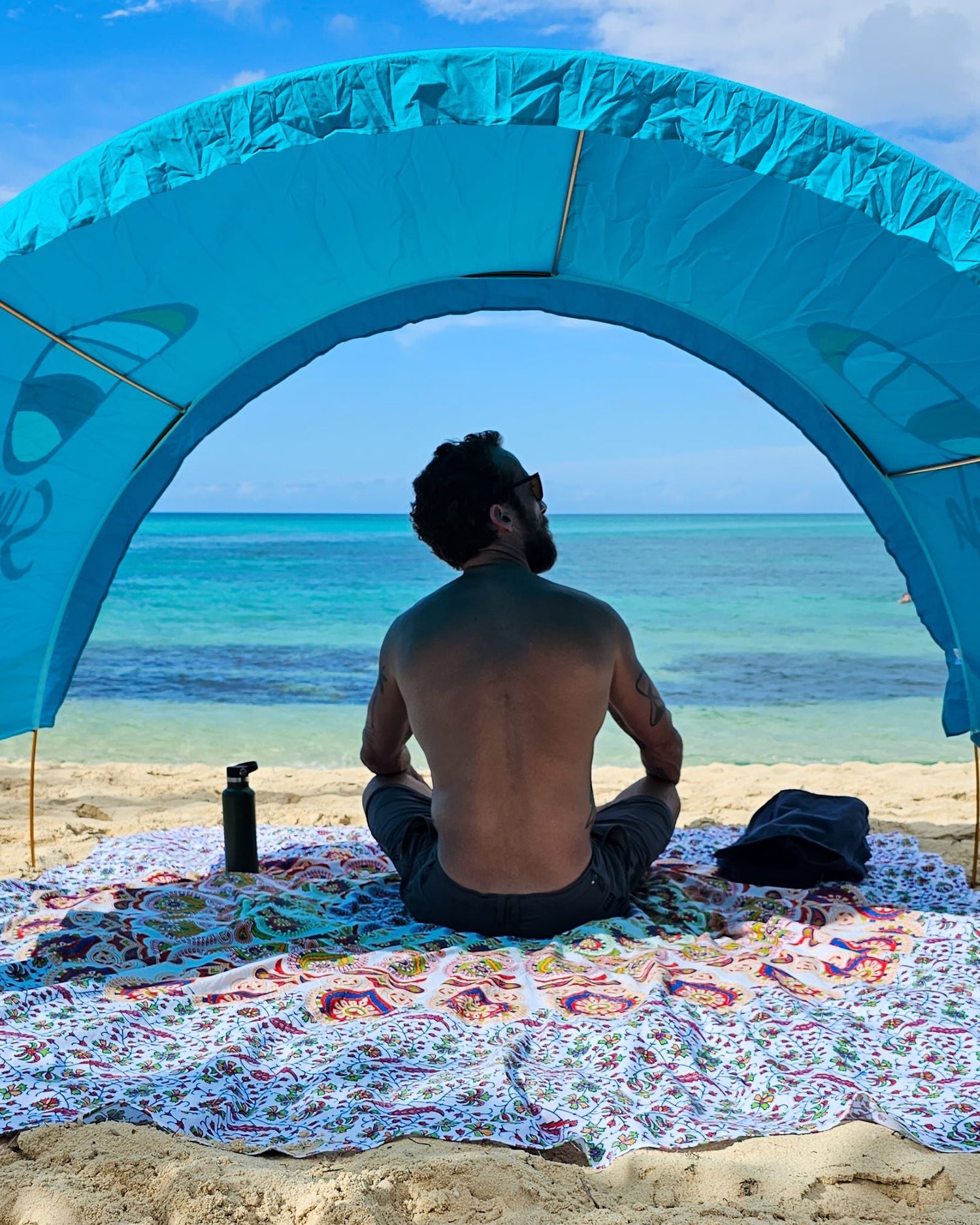 Turquoise Suniela Deluxe beach cabana providing UPF 50+ shade on sand