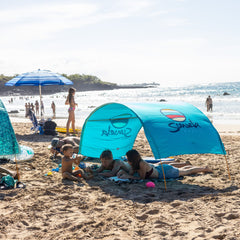 Family at the beach with a blue Suniela shade tent_printTurquoiseSuniela