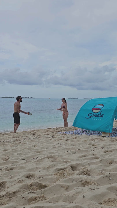 playing a friendly game of beach paddleball