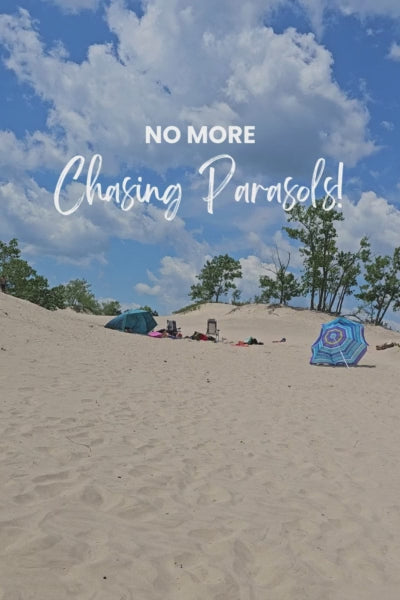 parasol blowing away while Suniela shade cabana withstands the strong wind