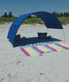 Blue cotton beach cabana with lots of shade beneath