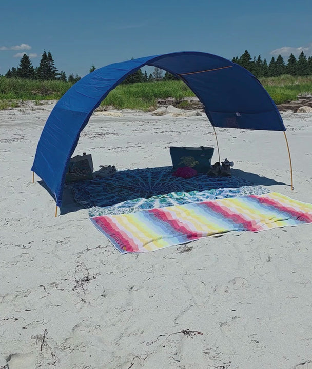 Blue cotton beach cabana with lots of shade beneath