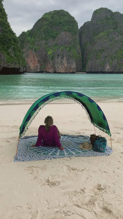 woman relaxes under her Suniela shade cabana at Maya Bay in Thailand