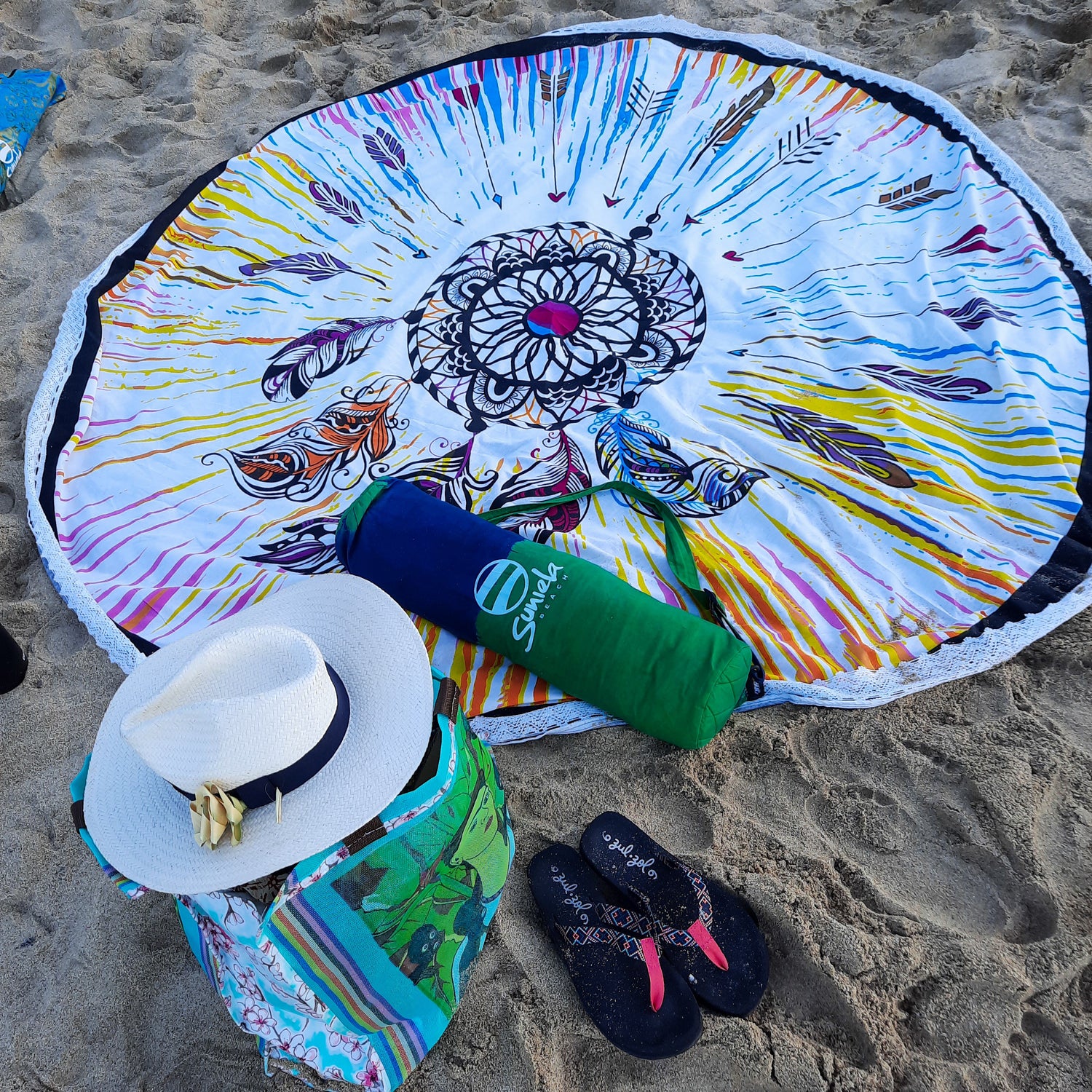 colourful hand dyed cotton beach mat with feathers design
